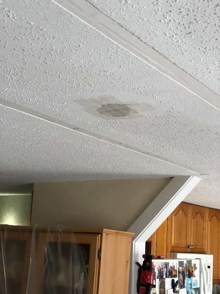 popcorn ceiling with a hole being patched